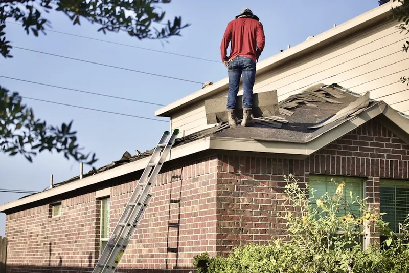 Professional roofer working on a residential roof in Olde Sawmill